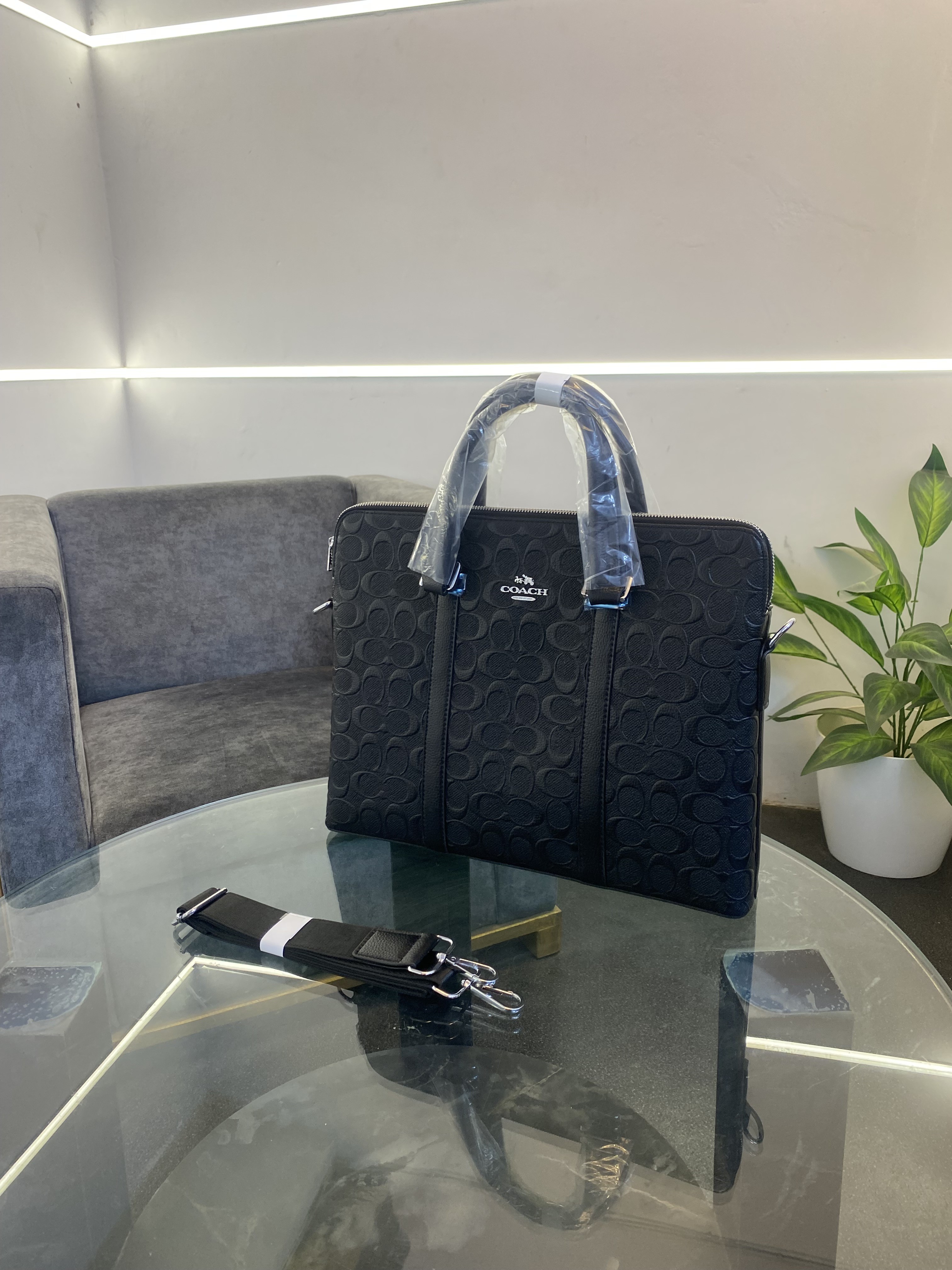 Coatch monogram leather laptop bag with double zip and back zip pocket